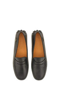 Tod’s women’s leather gommino loafer in black with classic moccasin design and tan lining