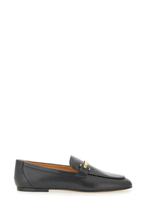 Tod’s women’s black leather loafer with a gold-tone metal bar detail across the toe
