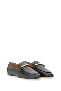 Tod’s women’s black leather loafers with a gold-tone metal bar across the toe for stylish comfort