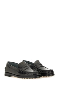 Tod’s women’s black leather loafers with glossy patent finish and classic moccasin-style stitching