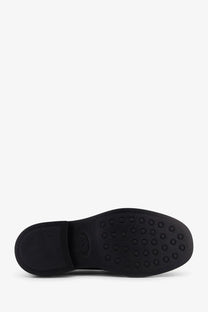 Black rubber sole with circular tread pattern and embossed logo on the back of Tods women’s red leather loafers