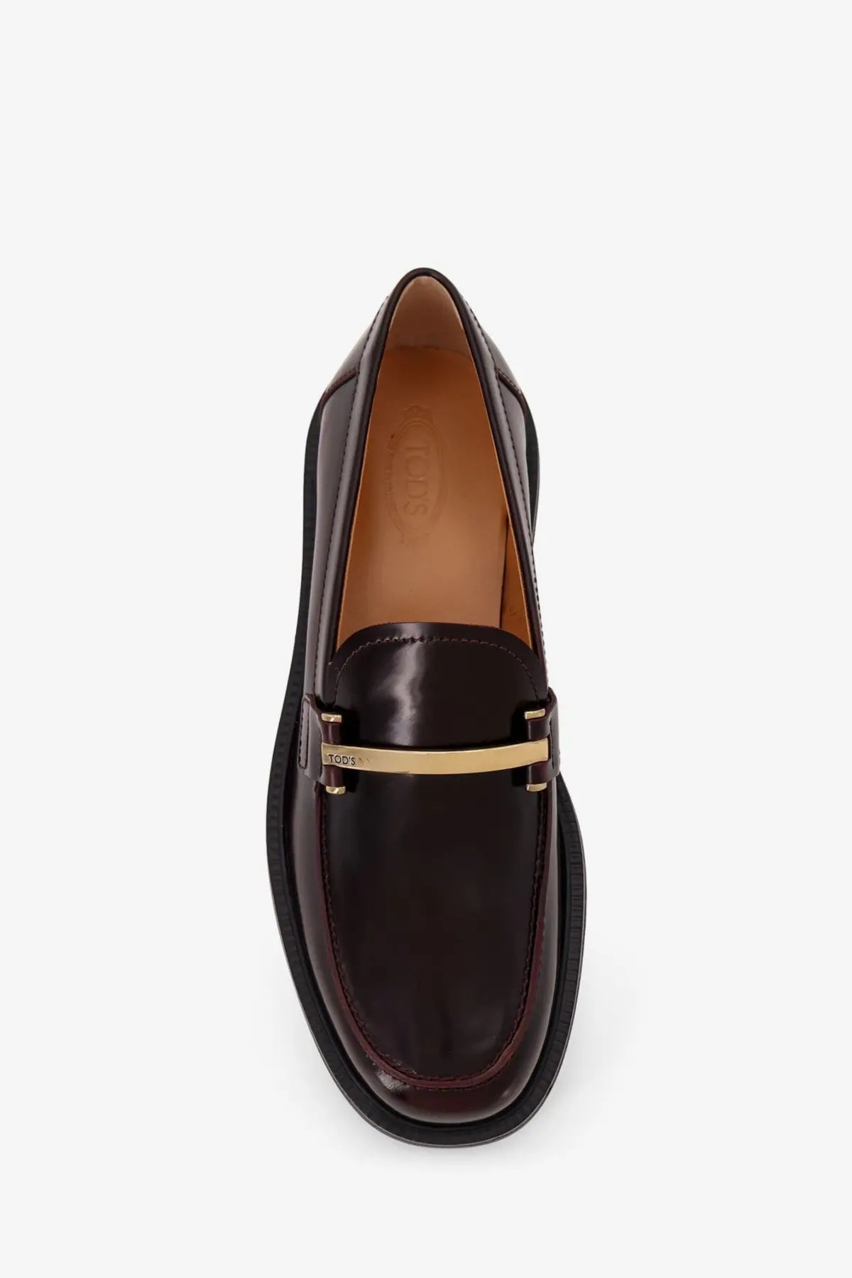 Tod’s women’s dark brown leather loafers with gold-tone metal bar across the toe in red product listing
