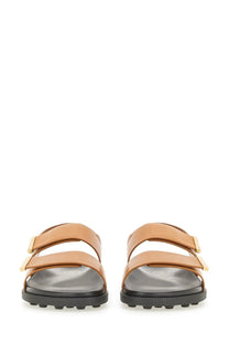 Tod’s women’s tan leather sandals with gold-tone buckle straps and black rubber sole for stylish comfort