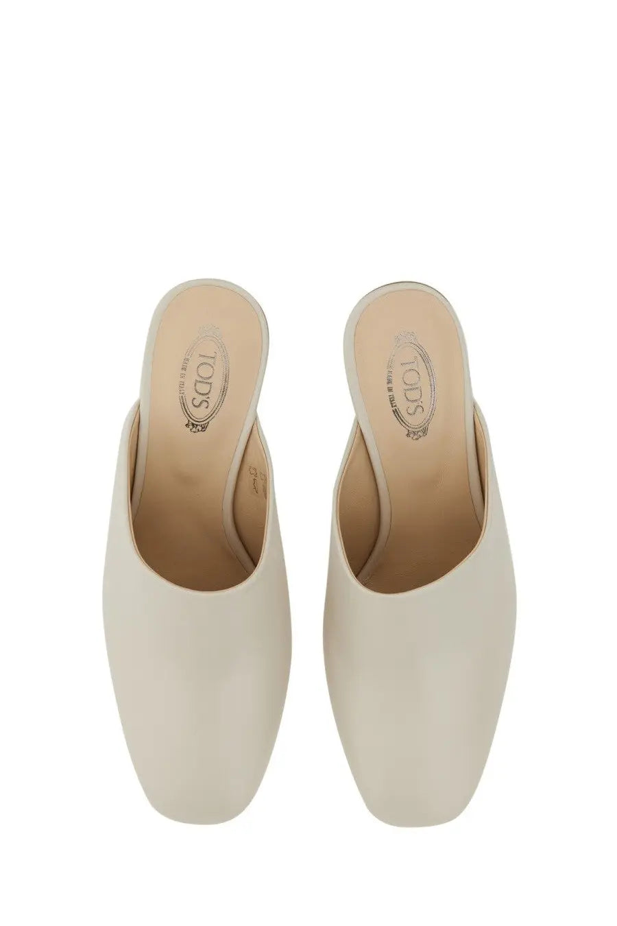 Cream-colored Tods women’s leather mules with sleek minimalist design and smooth leather finish