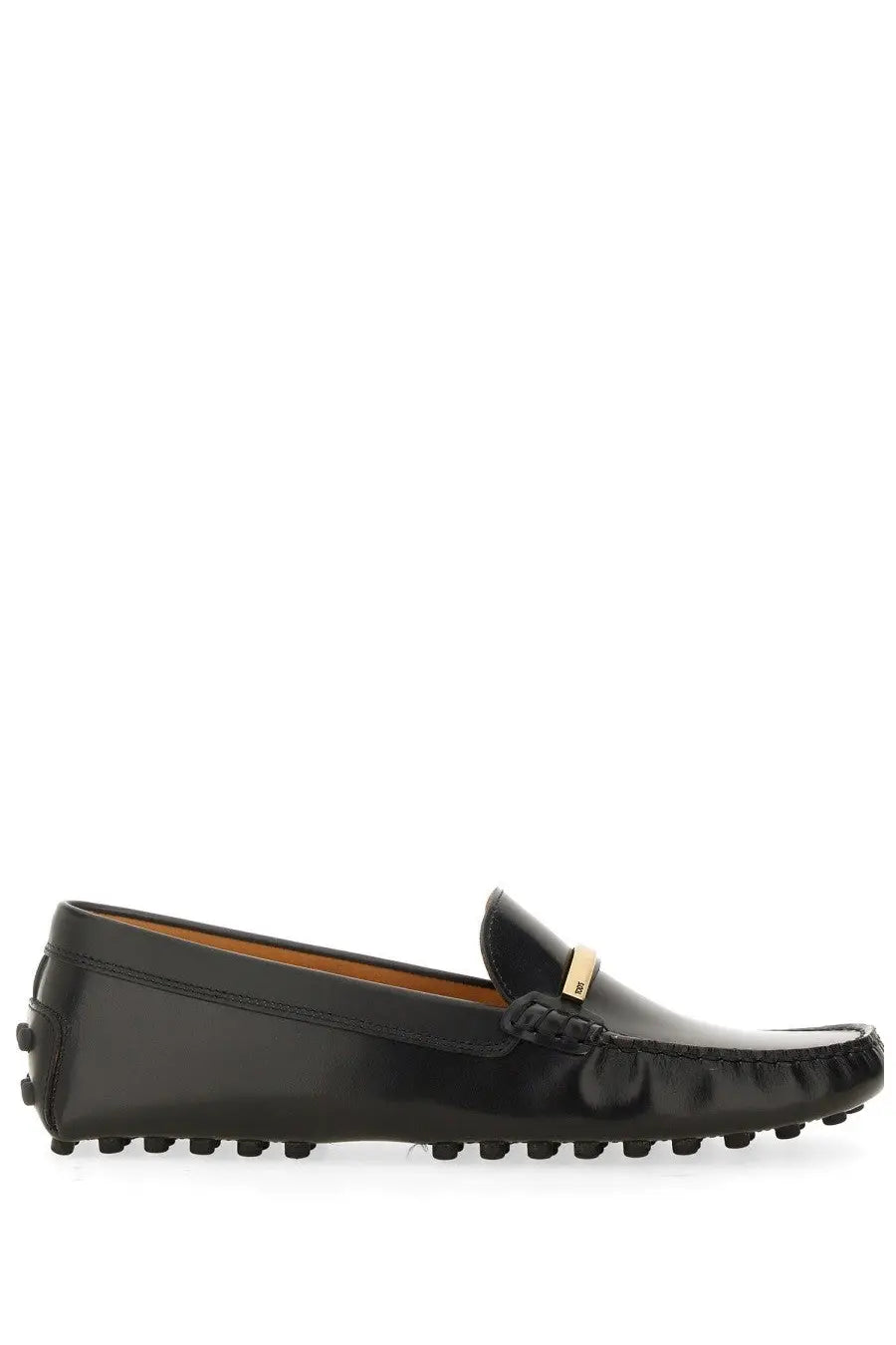 Tod’s women’s moccasin black leather loafers with gold-tone metal tab and textured rubber sole shown from the back
