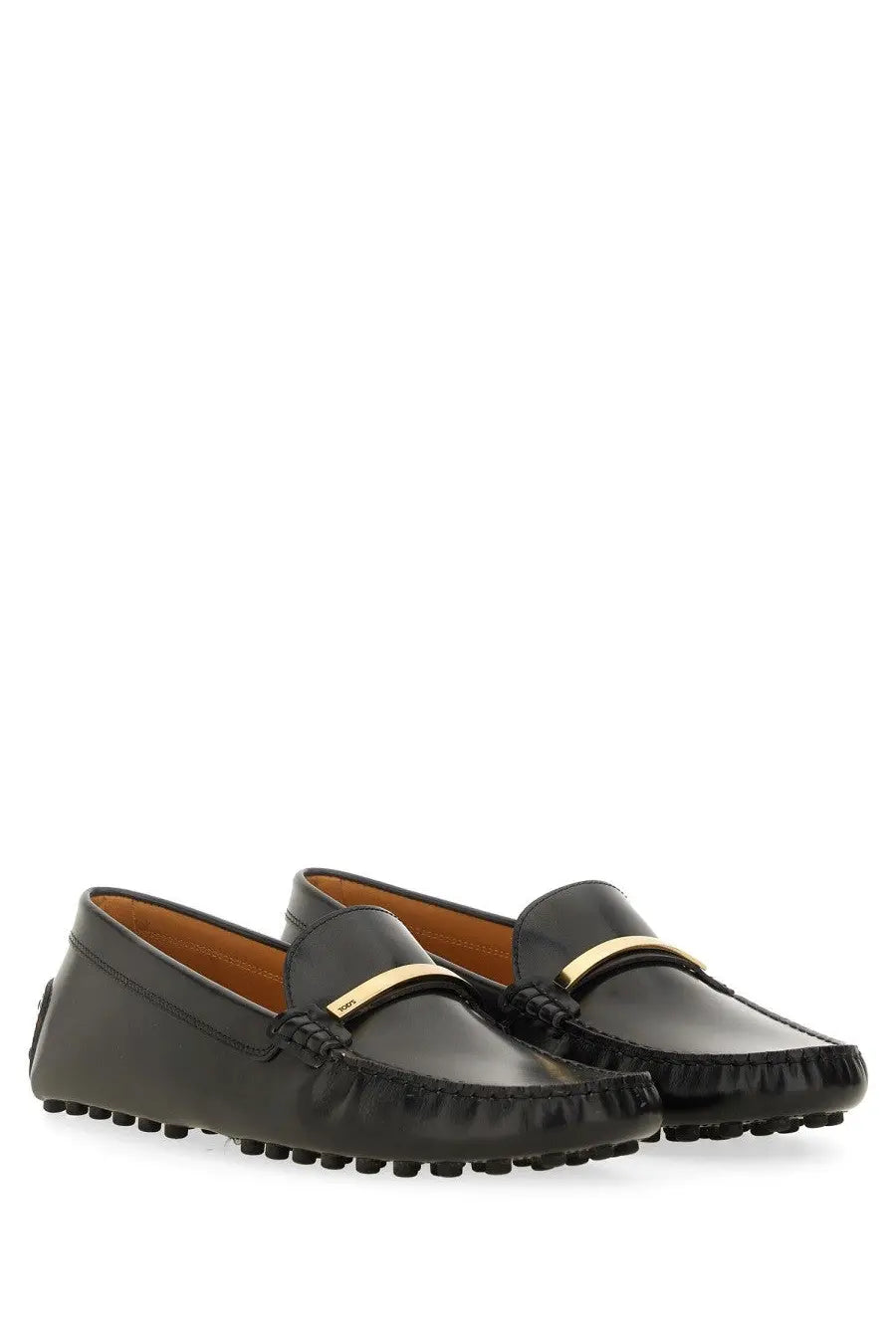 Tod’s women’s black leather moccasin loafers with a gold-tone metal bar across the toe