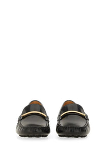 Tod’s women’s moccasin rubbermaid black leather loafers with a gold-tone metal bar across the toe