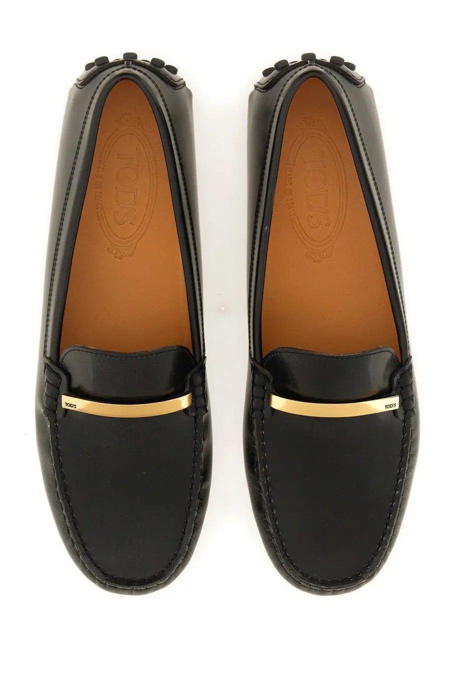 Tod’s women’s moccasin rubbermaid black patent leather loafers with gold-tone metal bar and stitched detailing