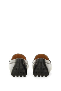Tod’s women’s moccasin Rubbermaid black leather loafers with a glossy finish and textured rubber soles