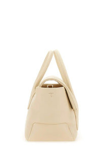 Cream-colored leather tote bag with structured design and minimalist branding from Tod’s women’s reverse small di bag white collection