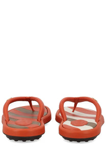 Tod’s women’s orange flip-flops with striped sole pattern and circular logo detail for casual wear