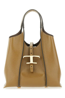 Tod’s women’s timeless mini shopping bag in tan pebbled leather with black trim and gold-tone t clasp