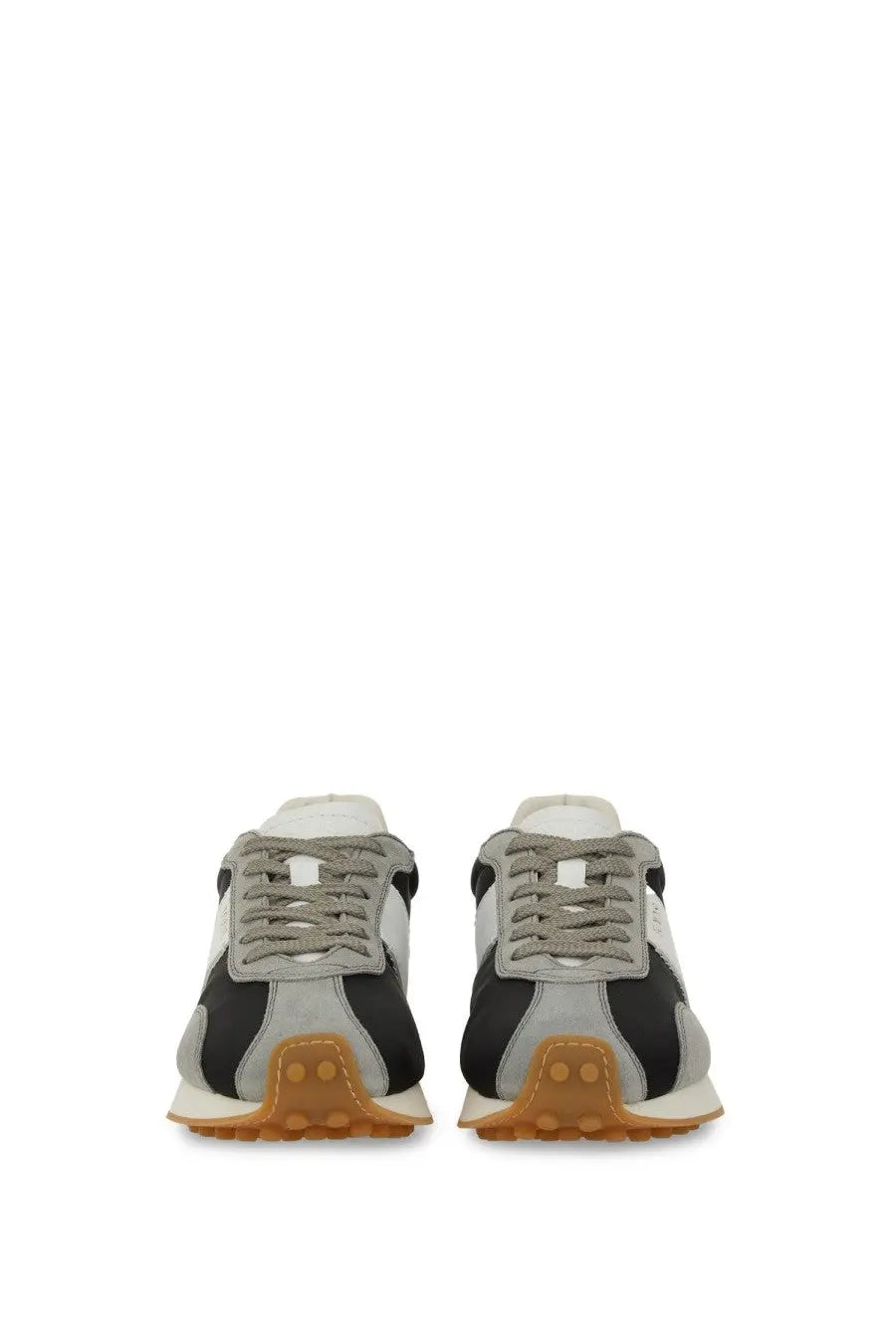 Tod’s women’s vintage sneaker grey in gray and black suede with tan rubber sole shown from the back side