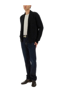 Tom Ford men’s double breasted black ribbed knit cardigan worn over white tee and dark blue jeans