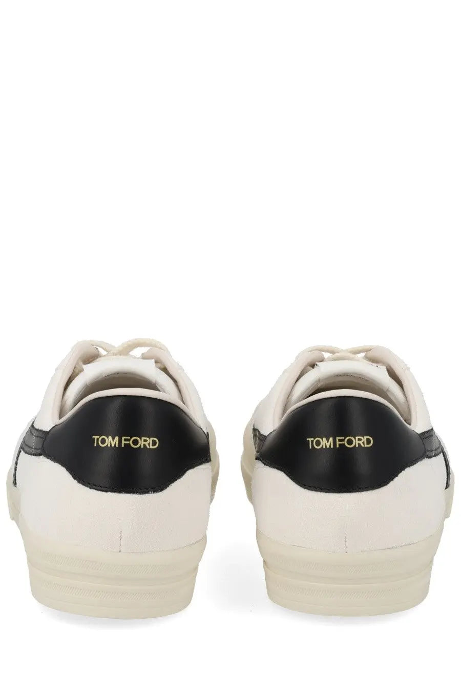 Back view of cream tom ford men’s jarvis sneakers with black leather accents and gold branding on the heel