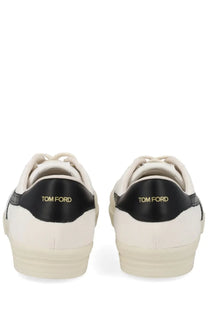 Back view of cream tom ford men’s jarvis sneakers with black leather accents and gold branding on the heel
