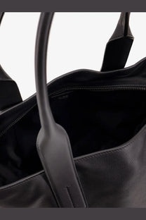 Tom Ford men’s black leather tote bag with sturdy handles and sleek minimalist design for shopping use