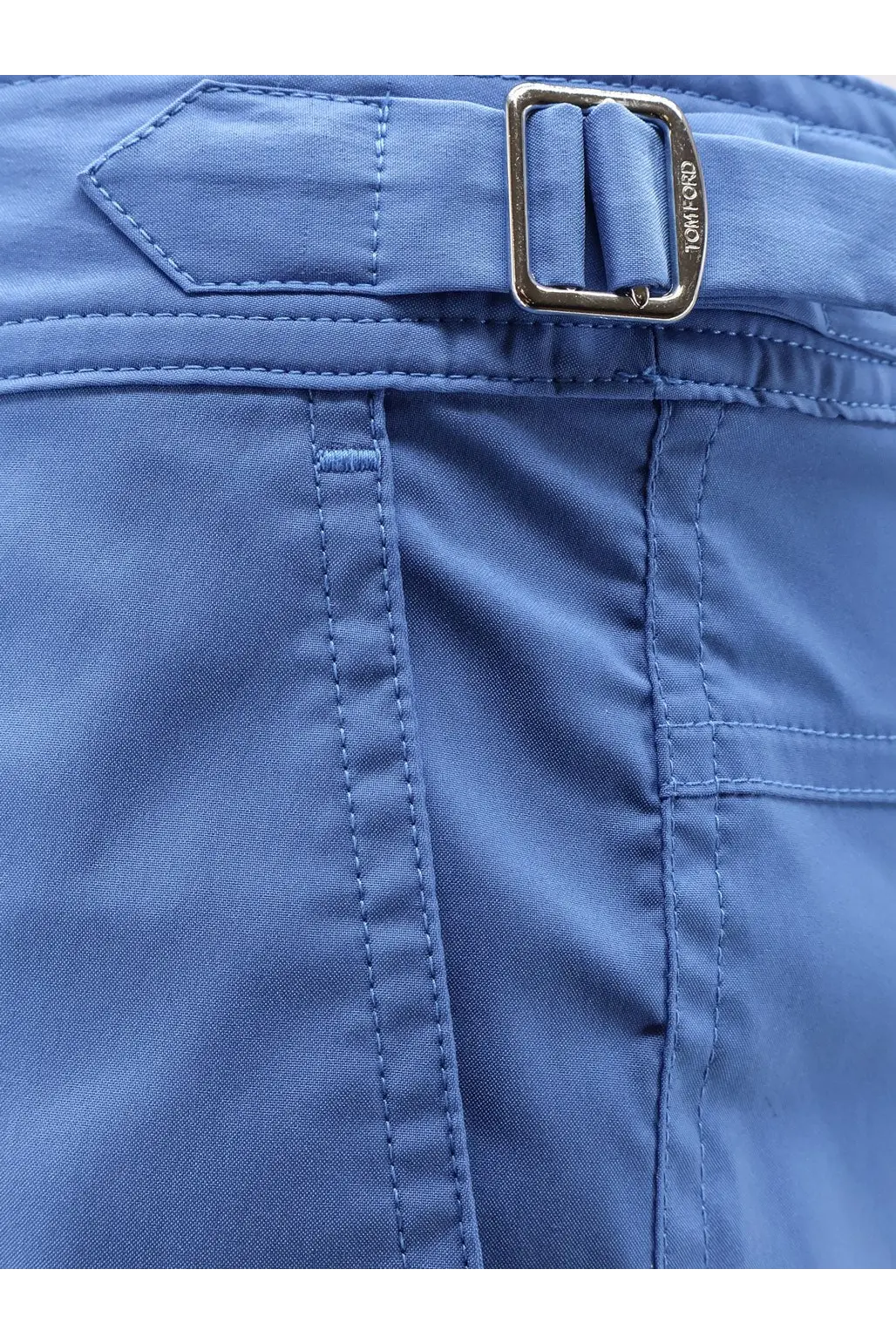 Blue tom ford men’s nylon swim trunks showing a belt loop with silver-toned metal buckle detail