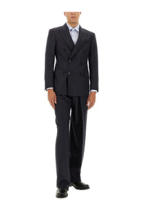 Dark navy double-breasted tailored suit with subtle texture paired with tom ford men’s blue pinstripe pants