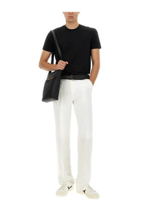 Black leather crossbody bag with gold zipper detail complementing tom ford mens regular fit shirt black