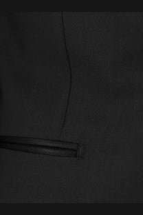 Black textured wool fabric with subtle diagonal weave and stitched pocket flap on tom ford men’s shelton stretch tuxedo