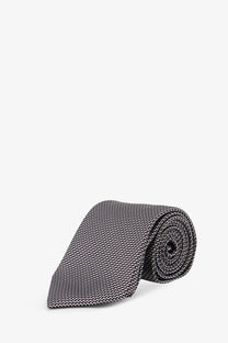 Tom Ford men’s silk tie black with gray and black zigzag pattern neatly rolled for formal wear