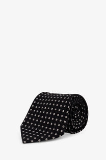 Black silk tie by tom ford with a subtle white quatrefoil pattern for men formal wear
