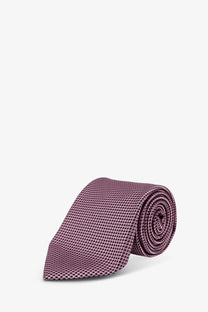 A neatly rolled mauve tom ford men’s silk tie with a subtle textured pattern and elegant finish