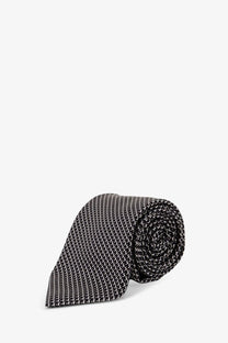 Tom Ford men’s silk tie blue with a sleek black and white pattern rolled neatly for display