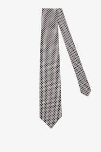 A sleek silver Tom Ford men’s silk tie with a subtle black geometric pattern in grey tones