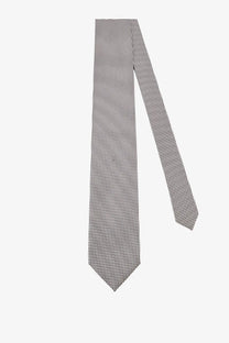 A tom ford men’s silk tie in silver with a sleek gray color and subtle repeating dot pattern
