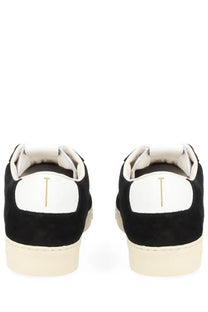 Black suede low-top tom ford men’s sneaker with white rubber sole and white heel tab featuring gold vertical line logo