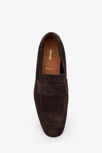 Tom Ford men’s suede loafers in dark brown with classic slip-on design and visible brand label on the insole