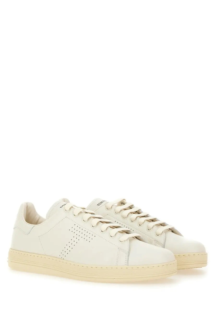 Cream-colored leather Tom Ford men’s Warwick sneaker with minimalist design and side perforated detailing in white