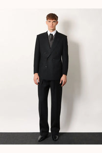 Tom Ford men’s black wool trousers with tailored fit and subtle texture perfect for formal occasions