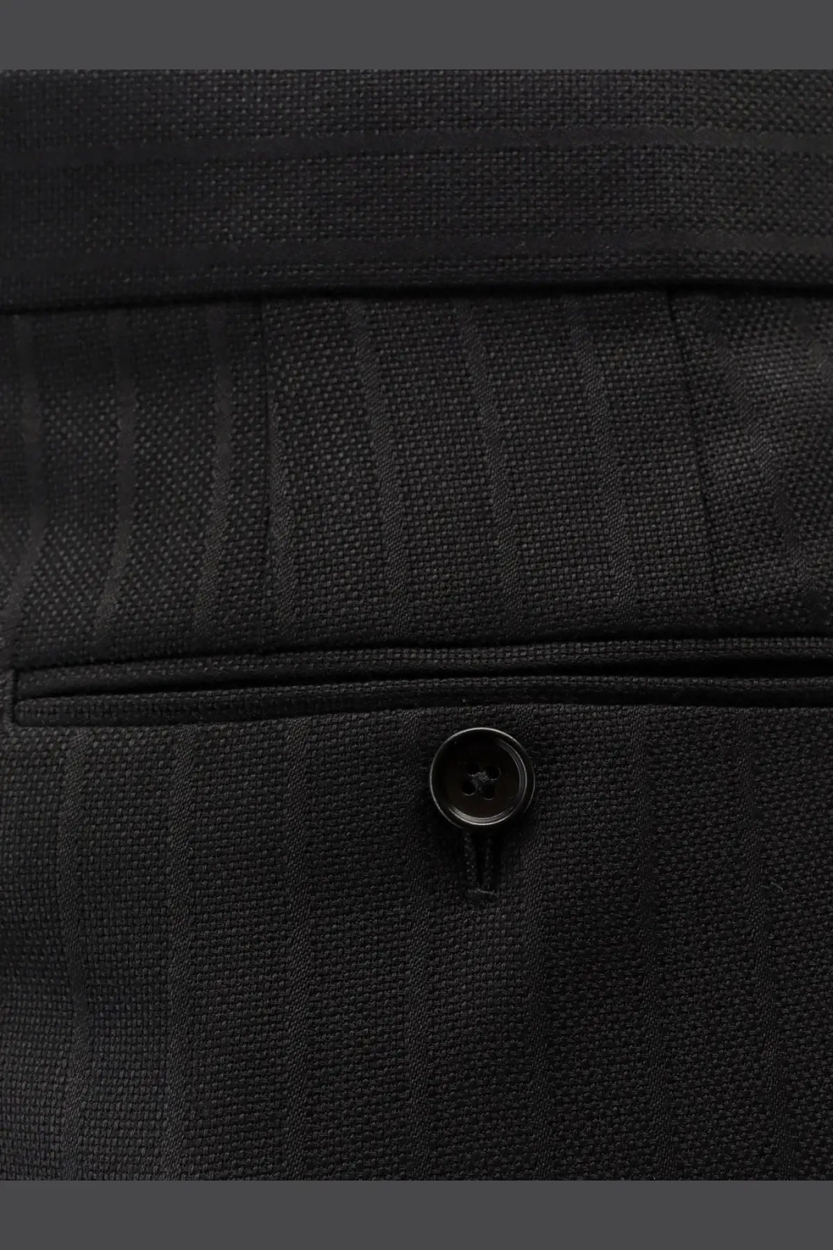 Tom Ford men’s black wool trousers with pinstripe texture and matching black button detailing
