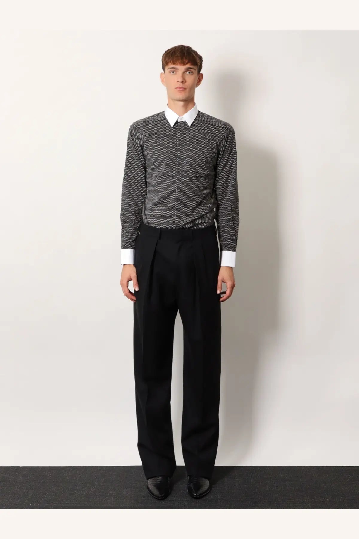 Tom Ford men’s black wool trousers with a sleek tailored fit and pleated design
