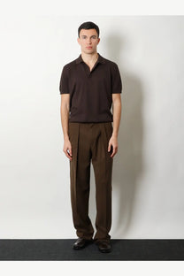 A dark brown short-sleeved polo shirt with classic collar and ribbed texture paired with tom ford brown wool trousers