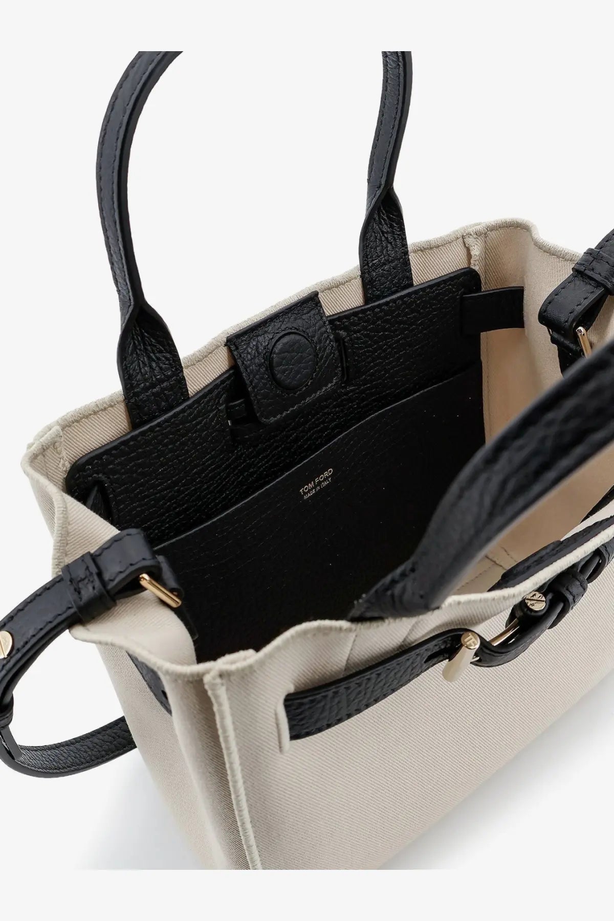 Beige canvas tote bag with black leather handles and gold-tone hardware from Tom Ford women’s Audrey collection