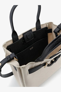 Beige canvas tote bag with black leather handles and gold-tone hardware from Tom Ford women’s Audrey collection