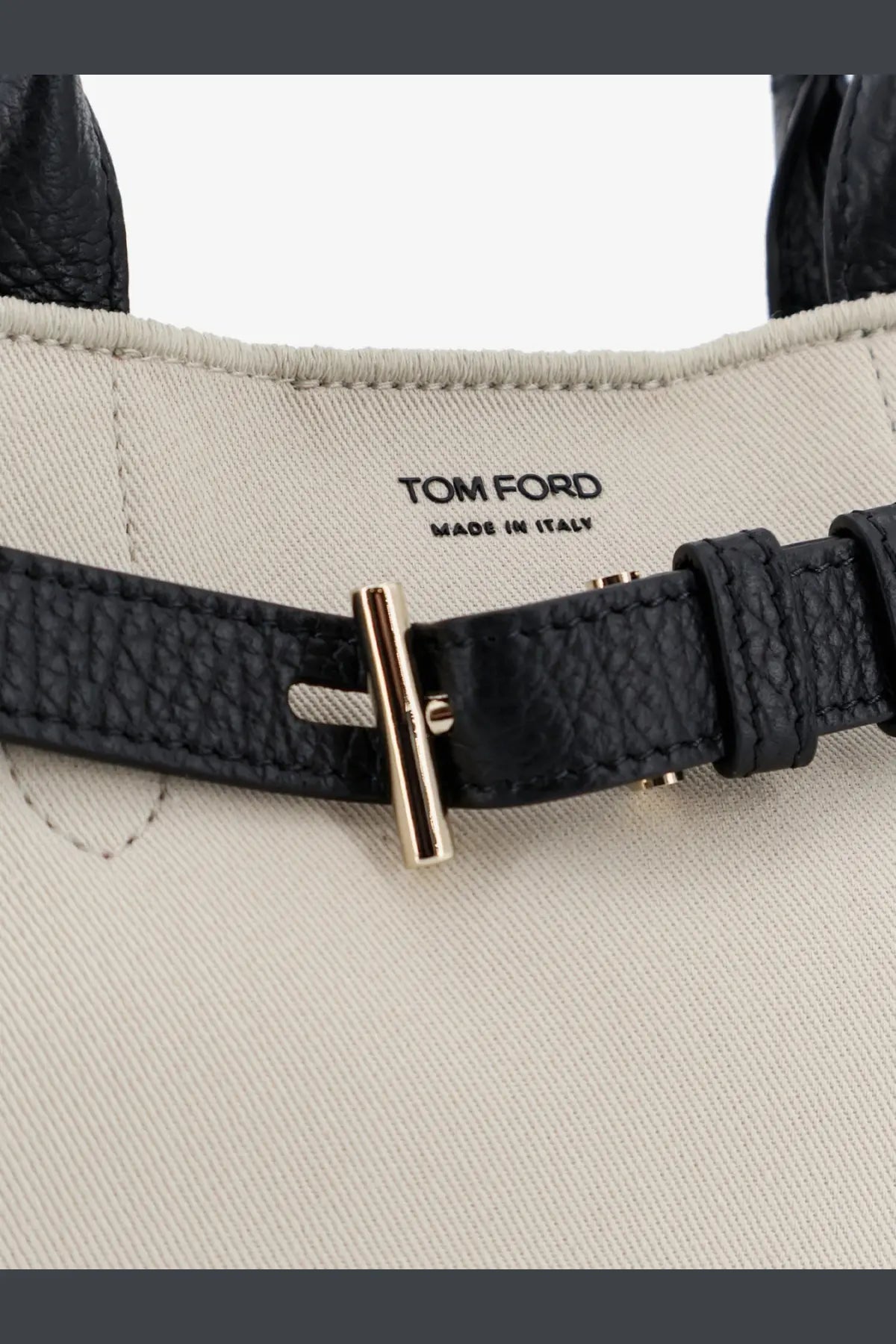 Black leather strap with gold tone t bar buckle featuring tom ford logo and made in italy inside tom ford womens audrey canvas handbag black