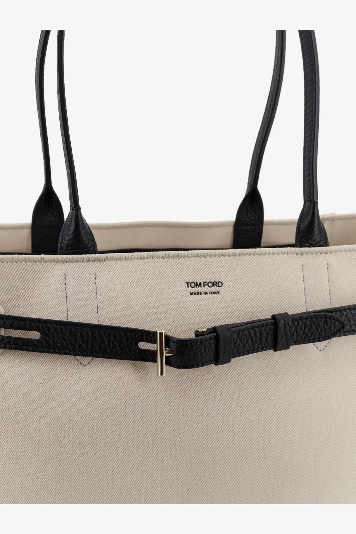 Beige Tom Ford women’s canvas tote bag with black leather handles and textured black leather belt strap with silver buckle