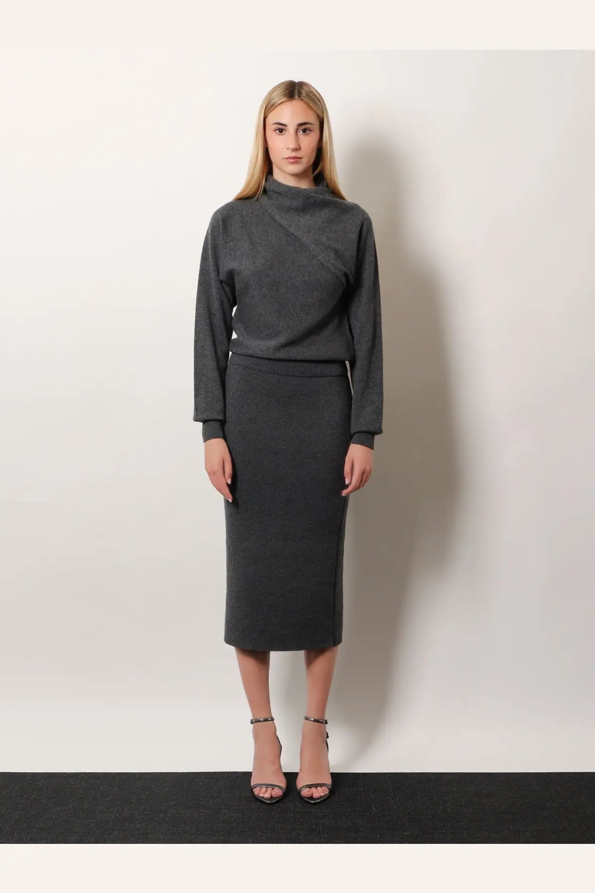 Tom ford women’s cashmere and cotton grey turtleneck sweater with high neckline and asymmetrical seam paired with pencil skirt