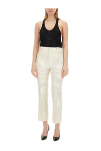 Cream-colored trousers with thin vertical stripes and a cropped straight-leg cut paired with tom ford women’s black jersey tank top