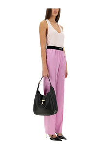 Black leather hobo bag with gold-tone t-shaped clasp complementing tom ford women’s blue jersey top