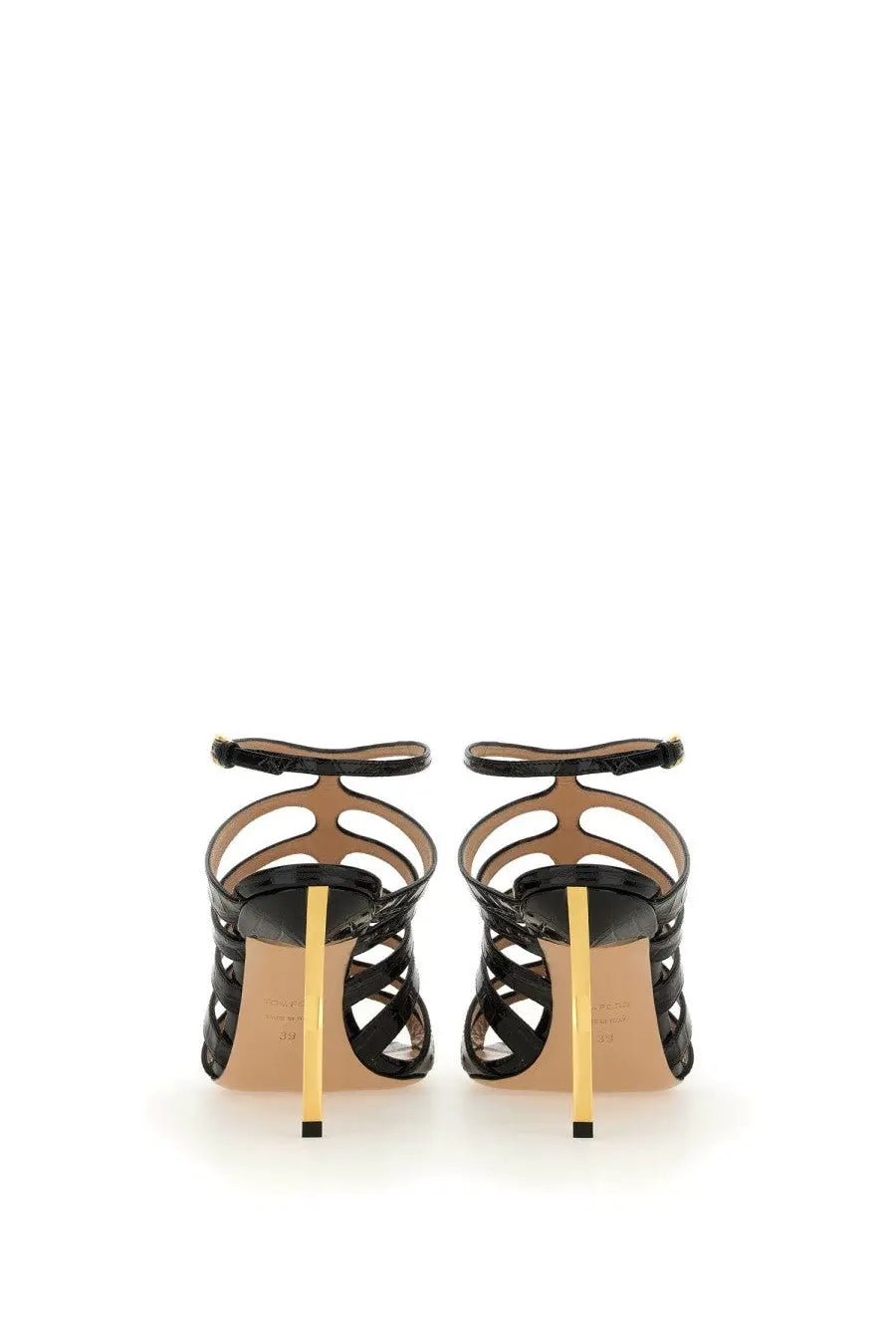 Tom Ford women’s black leather sandal with patent leather straps and a striking gold tone heel visible from the back