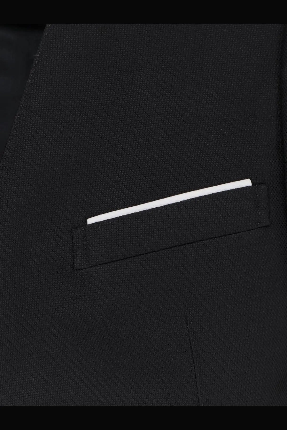 A crisp white pocket square neatly folded in the breast pocket of a tom ford women’s black wool and silk blazer