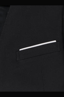 A crisp white pocket square neatly folded in the breast pocket of a tom ford women’s black wool and silk blazer