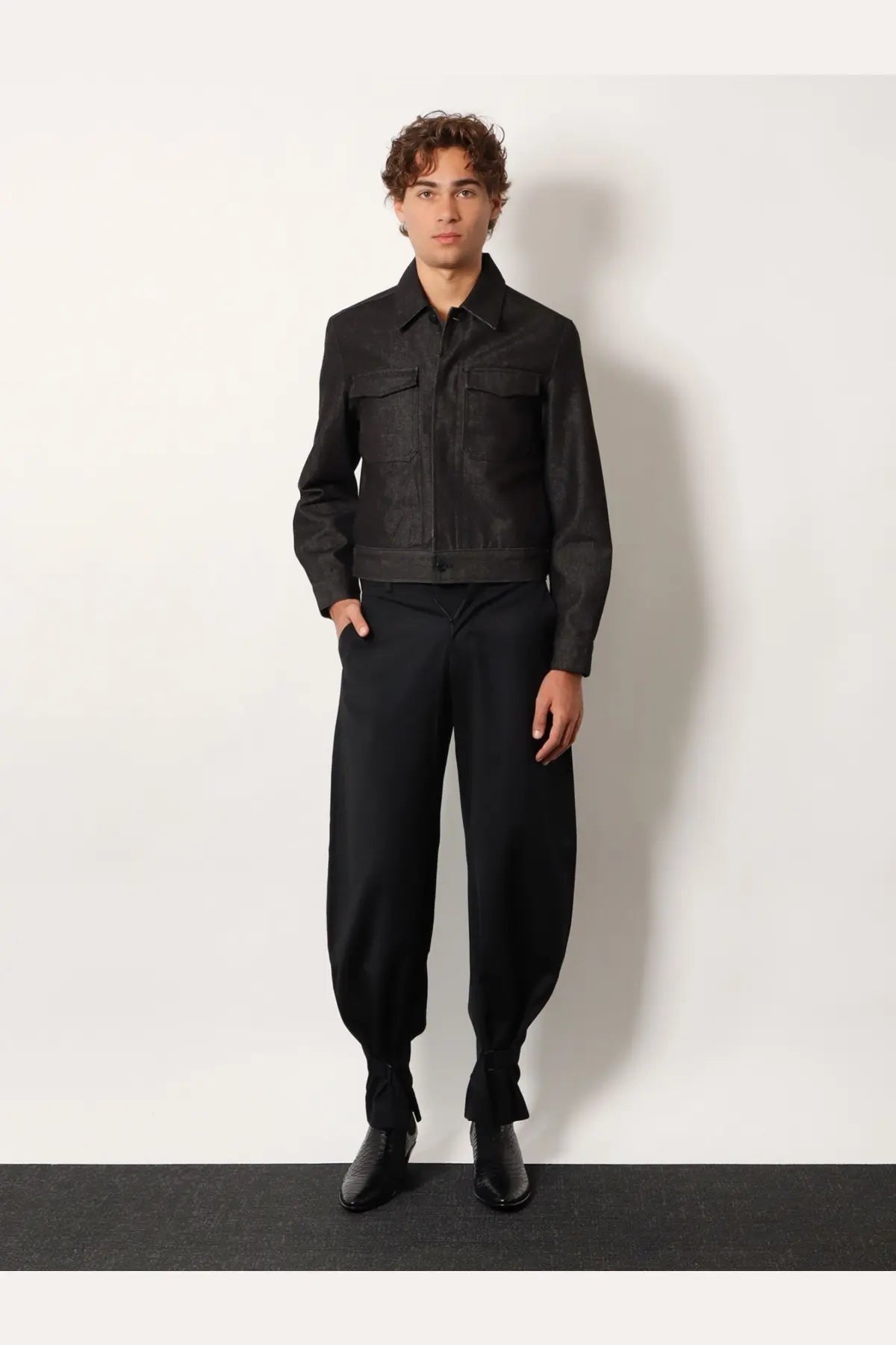 Tonywack men’s grey denim jacket with black leather sleeves featuring two chest pockets and buttoned front closure