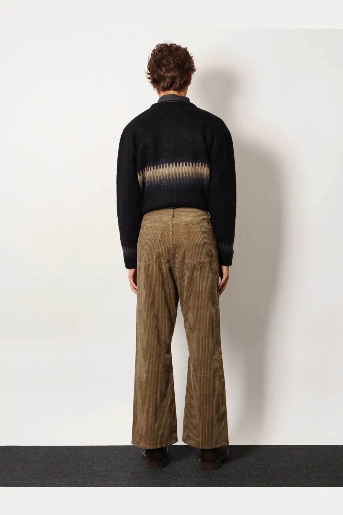 Brown corduroy flared trousers with subtle vertical ribbed texture from tonywack unisex collection in beige